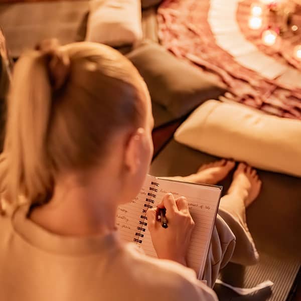 Woman writing down Reiki notes at course
